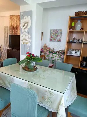 a dining room with a table with blue chairs at VILLA APHRODITE SOUGIA apt1 in Kamária