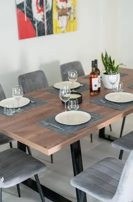a wooden table with plates and wine glasses on it at Callista City Living in Chania Town