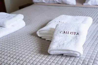a hotel room with towels on a bed at Callista City Living in Chania Town