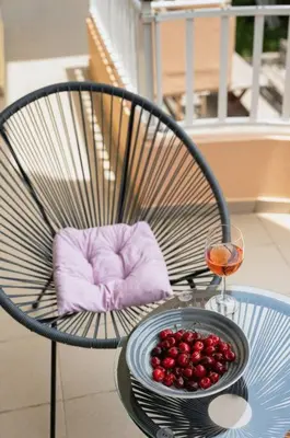 a bowl of fruit and a glass of wine on a table at Callista City Living in Chania Town