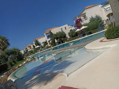 a swimming pool in the middle of a resort at Infinity Night Villa in Chania Town