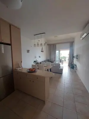 a kitchen and living room with a couch and a table at Infinity Night Villa in Chania Town