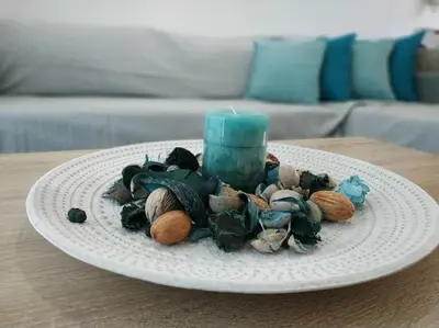 a plate with shells and a blue candle on a table at StelisIoanna in Chania Town