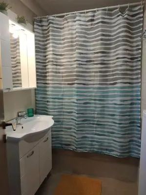 a bathroom with a sink and a shower curtain at StelisIoanna in Chania Town