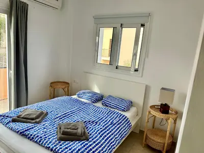 a bedroom with a bed with two towels on it at Villa Albama in Darmarochori