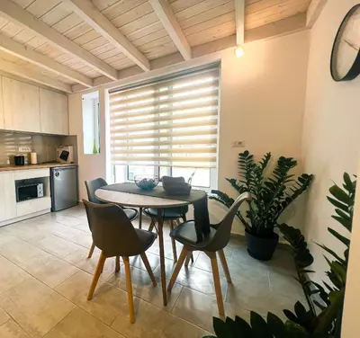 a kitchen and dining room with a table and chairs at Kerdos Home in Kalyves