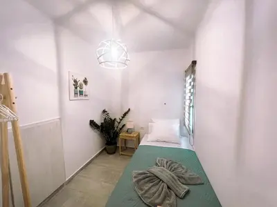 a small room with a bed and a light fixture at Kerdos Home in Kalyves