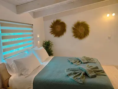 a bedroom with a bed with towels on it at Kerdos Home in Kalyves