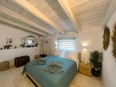 a bedroom with a bed with a blue comforter at Kerdos Home in Kalyves