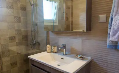a bathroom with a sink and a mirror at Archontissa Kakodiki - Paleochora in Áyioi Theódhoroi