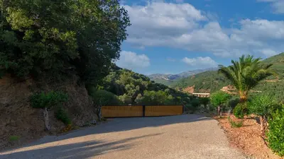 a road with a fence on the side of a mountain at Archontissa Kakodiki - Paleochora in Áyioi Theódhoroi