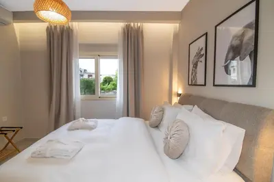 a bedroom with a large white bed and a window at Casa Moca in Chania Town