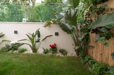 a garden with plants and flowers next to a fence at Casa Moca in Chania Town