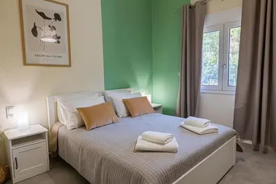 a bedroom with a bed with two towels on it at Adriana Apartment in Agia Marina Nea Kydonias