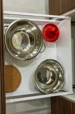 three different types of metal bowls on a shelf at Adriana Apartment in Agia Marina Nea Kydonias