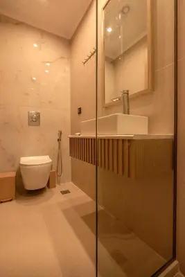 a bathroom with a shower and a toilet and a sink at Eva's apartments in Kissamos