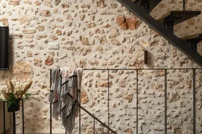 a stone wall with towels hanging on a fence at Lovelia Maisonette Chania in Chania Town