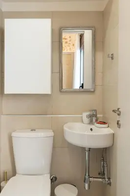 a bathroom with a toilet and a sink and a mirror at Lovelia Maisonette Chania in Chania Town
