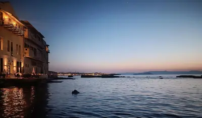 a duck swimming in a river at sunset at Lovelia Maisonette Chania in Chania Town
