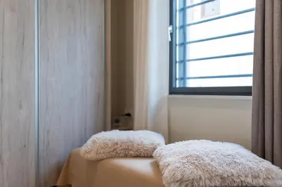 two furry pillows sitting on top of a bench in a room at Helios studio next to the sea BY APOKORONAS-VILLAS in Kalyves