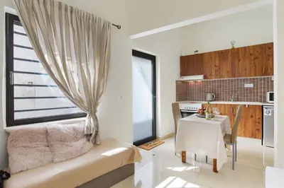 a living room with a couch and a table at Helios studio next to the sea BY APOKORONAS-VILLAS in Kalyves