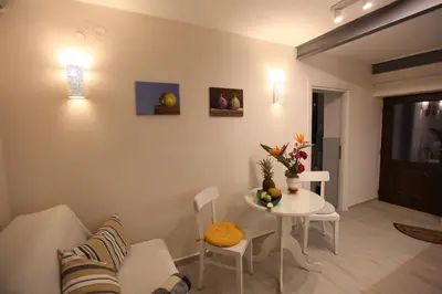 a living room with a table and a couch at Kabanas suite 1 in Chania Town