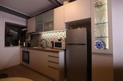 a kitchen with a refrigerator and a microwave at Kabanas suite 1 in Chania Town