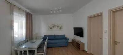 a living room with a blue couch and a table at Aeropis Villa, Chania in Chania Town