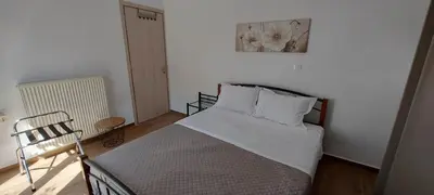 a bedroom with a bed and a picture on the wall at Aeropis Villa, Chania in Chania Town