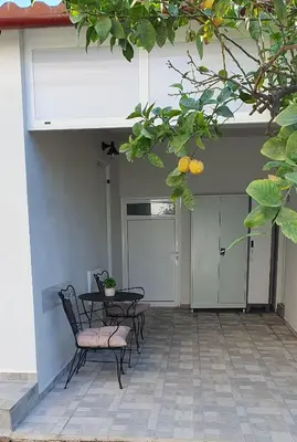 a patio with a table and chairs in a building at Aeropis Villa, Chania in Chania Town