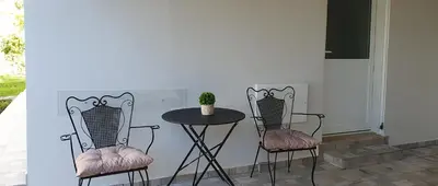 a table and two chairs and a table with a plant at Aeropis Villa, Chania in Chania Town