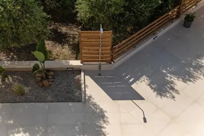 an overhead view of a patio with a wooden bench at Oliva Verde Residences in Galatás