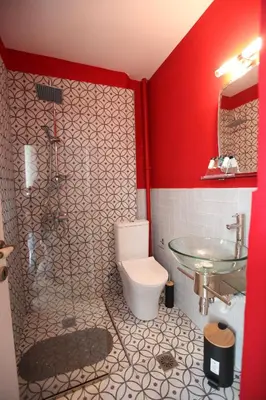 a bathroom with a toilet and a glass shower at Kabanas 2 luxury Suite in Chania Town