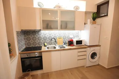 a small kitchen with a sink and a microwave at Kabanas 2 luxury Suite in Chania Town