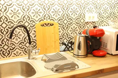 a kitchen counter with a sink and a microwave at Kabanas 2 luxury Suite in Chania Town