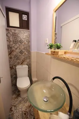 a bathroom with a toilet and a glass sink at Kabanas 2 luxury Suite in Chania Town