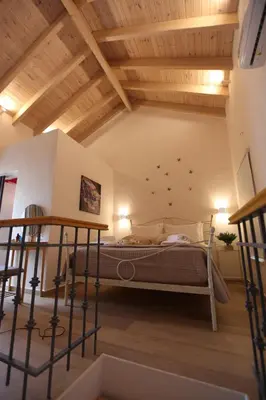 a bedroom with a bed in a room with wooden ceilings at Kabanas 2 luxury Suite in Chania Town