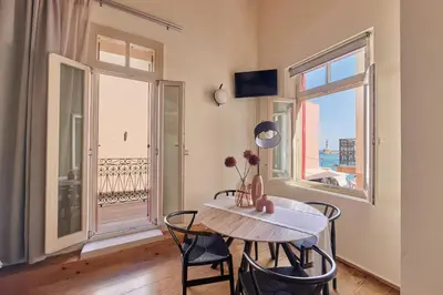 a dining room with a table and chairs and a window at Filomeli Estate in Chania Town