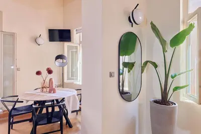 a dining room with a table and a mirror at Filomeli Estate in Chania Town