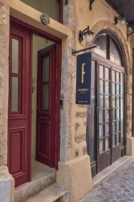 a building with two red doors and a sign on it at Filomeli Estate in Chania Town
