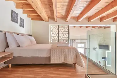 a bedroom with a bed and a glass wall at Filomeli Estate in Chania Town