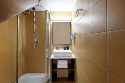 a bathroom with a sink and a toilet and a mirror at Filomeli Estate in Chania Town