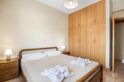 a bedroom with a bed with white towels on it at Patelakis Apartment near the Beach in Chania Town