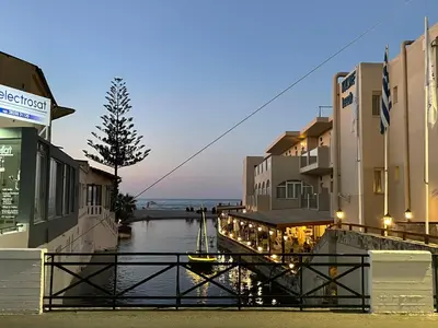 a group of buildings next to a body of water at Julia's cottage in Kalyves