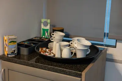 a tray of dishes and cups on a kitchen counter at Black Suites in Chania Town