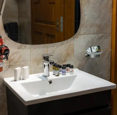 a white sink in a bathroom with a mirror at Black Suites in Chania Town