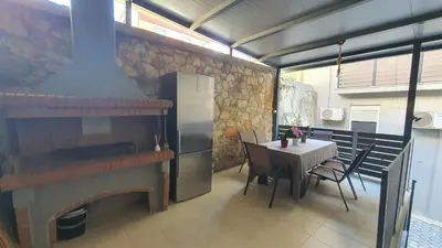 a kitchen with a stove and a table and a refrigerator at Black Suites in Chania Town