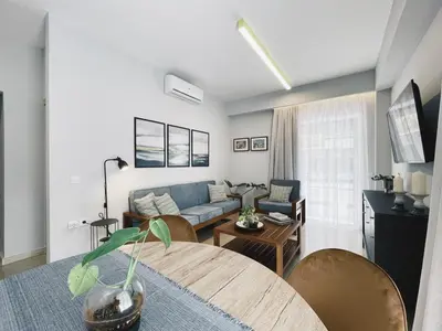 a living room with a couch and a table at Urban Hive Chania, Your City Basecamp - Fiber Wifi in Chania Town