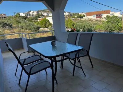 a blue table and two chairs on a balcony at blue and green II in Chania Town