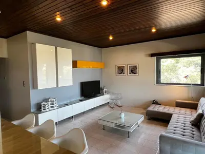 a living room with a couch and a tv at blue and green II in Chania Town